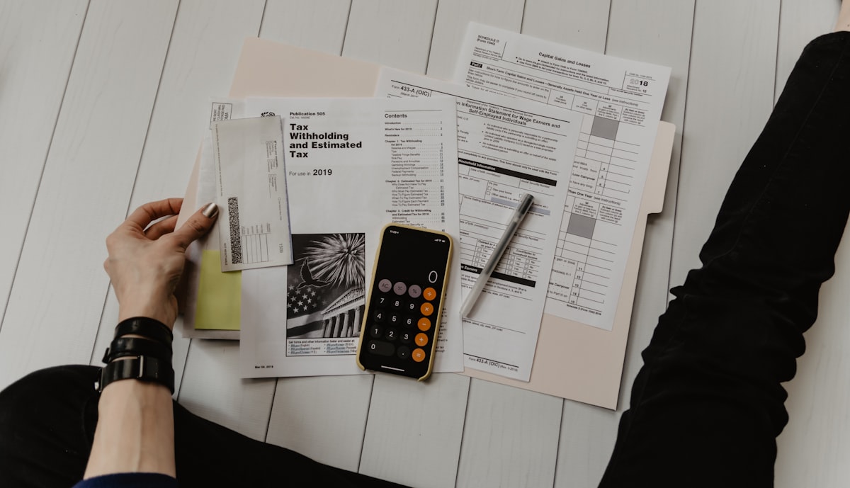 A calculator and notes used during a pay equity review