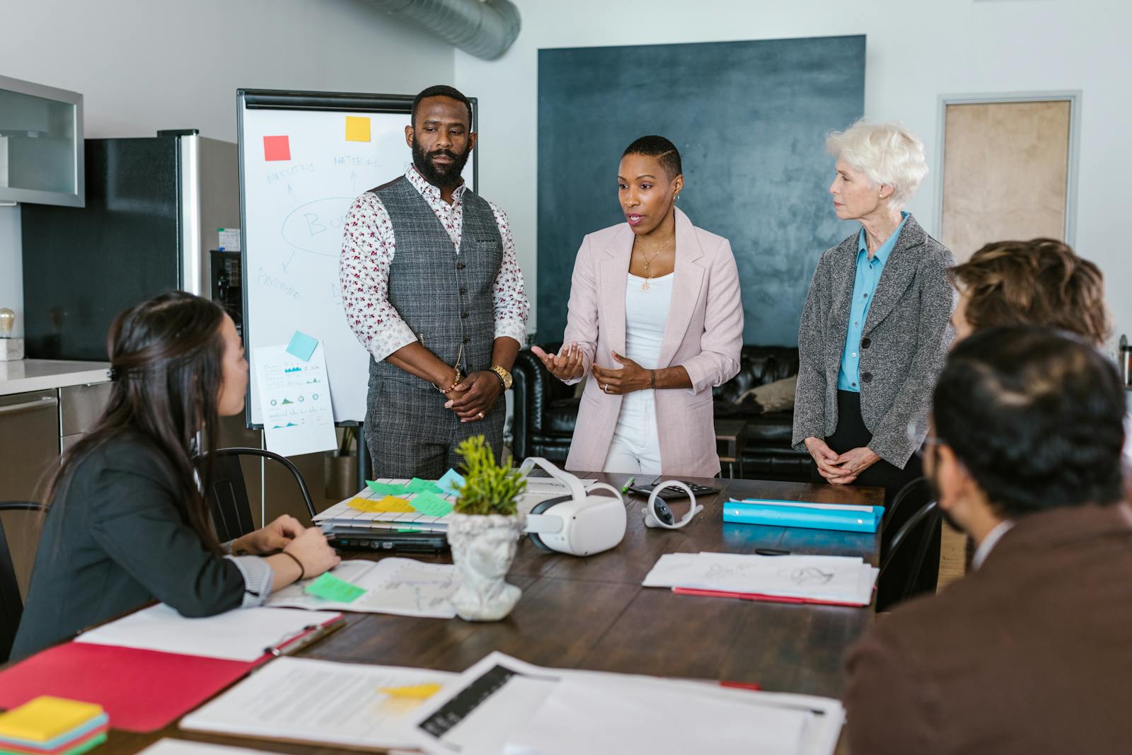 Diverse team in an active consultation meeting around a boardroom table